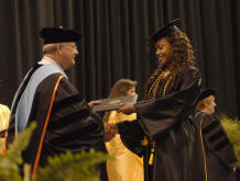 FTCC's President handing a diploma to a student at graduation
